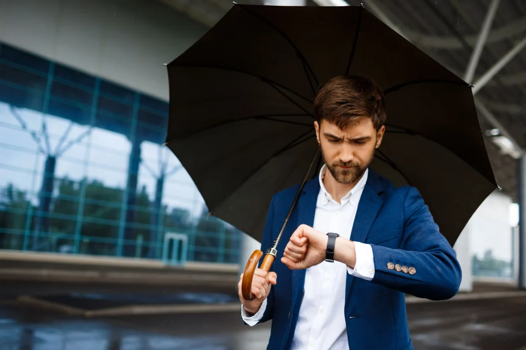 Man under the rain in a waterproof atm watch min ATM در ساعت های مچی چیست و چگونه میزان مقاومت در برابر آب را تعیین میکند؟ ATM در ساعت های مچی چیست و چگونه میزان مقاومت در برابر آب را تعیین میکند؟