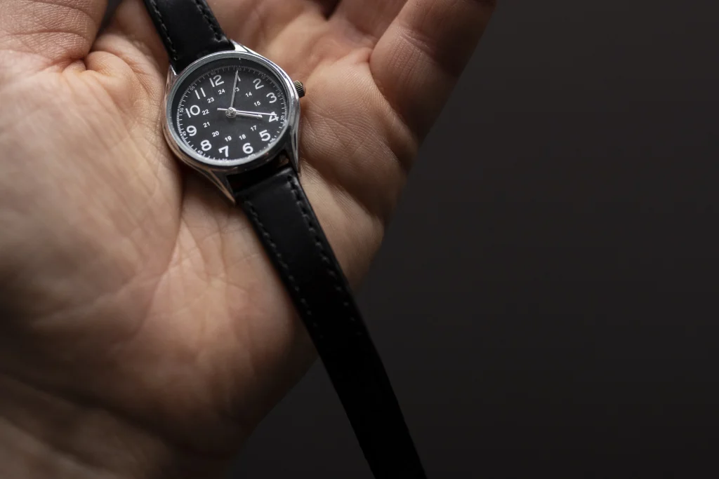 Classic Michael Candy branded leather strap watch on the hand of a middle aged man پشت پرده فروش ساعت های مچی پشت پرده فروش ساعت های مچی